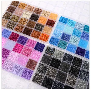 Detail shot of colorful glass seed and tube beads inside clear transparent storage organizer boxes.