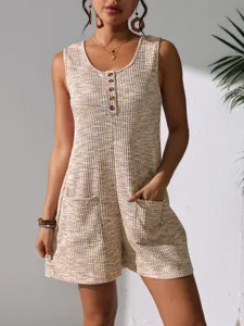 Detailed view of sleeveless waffle knit romper with decorative buttons and front pockets