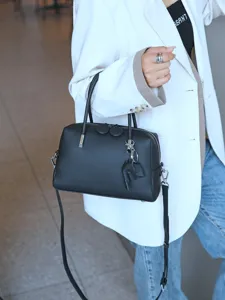 Black genuine leather Boston handbag for women, stylish top handle and crossbody bag.