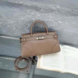 Classic brown leather top handle shoulder bag with metal lock detail for daily women fashion.