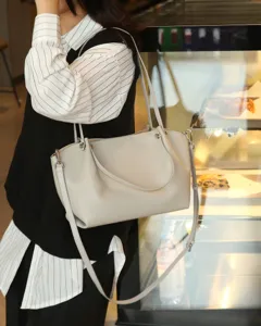Genuine leather shoulder tote bag detail view, soft cowhide material with metal hardware.