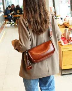 Vintage genuine leather pillow shoulder bag for women, wide strap crossbody dumpling bag.