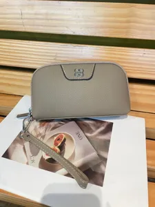 Genuine leather clutch wallet for women, minimalist card holder and coin purse with wrist strap.