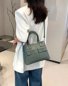 Detailed view of genuine leather shoulder handbag with front pockets, elegant daily commute design.
