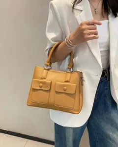 Genuine leather top-handle crossbody bag with dual front pockets for women, stylish tote bag.