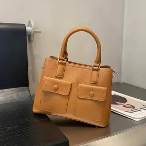Genuine leather handbag for women, stylish tote shoulder bag with top handles and pockets.