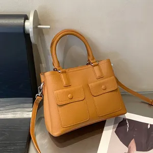 Brown genuine leather handbag for women, casual tote bag with top handle and crossbody strap.