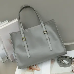 Grey genuine leather tote bag for women, retro casual shoulder handbag with adjustable straps.