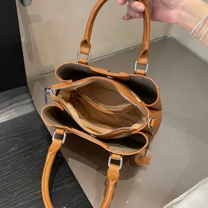 Genuine leather tote bag interior view, brown top layer cowhide commuter handbag detail.