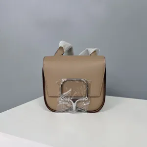 Leather saddle bag detail showcasing exquisite craftsmanship, premium cowhide, and stylish silver hardware.