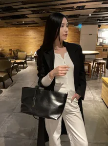 Stylish black leather tote bag for women, soft cowhide shoulder bag with large capacity.