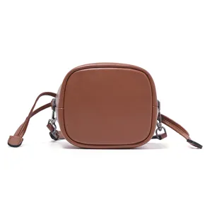 Brown leather bucket bag with drawstring, stylish shoulder and crossbody design for women.