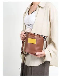 Brown leather drawstring bucket bag, versatile casual crossbody and shoulder bag.