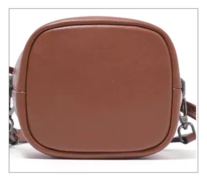 Detailed bottom view of the brown leather bucket bag showcasing durable material and fine stitching.
