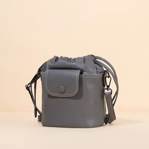 Stylish grey leather drawstring bucket bag, versatile cross-body shoulder bag for daily commuting.