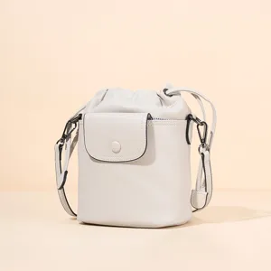 Elegant leather bucket bag with drawstring closure and crossbody strap for women daily commute.
