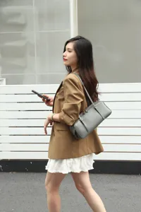 Stylish grey leather underarm bag for women, minimalist baguette shoulder bag design.