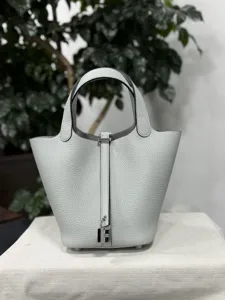 Élégant sac seau en cuir gris clair avec cadenas argenté, superbe sac à main pour femme.