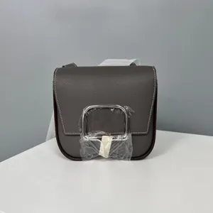 Elegant leather saddle crossbody bag for women, stylish miniature shoulder bag with hardware.