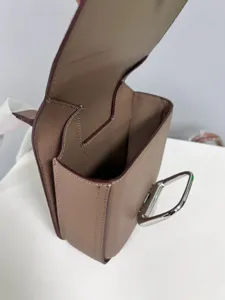 Detail view of genuine leather crossbody saddle bag showing interior compartments and hardware.