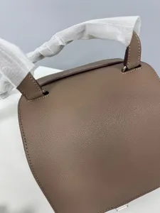 Premium leather saddle shoulder bag for women, stylish minimalist design with elegant grain.