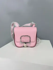 Pink leather mini saddle crossbody bag for women, stylish shoulder bag with metal buckle.