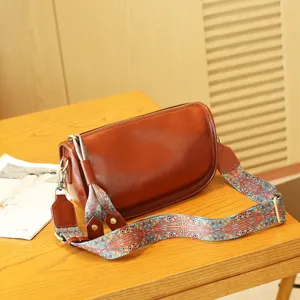Brown leather pillow shoulder bag with colourful ethnic pattern wide strap detail