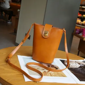 Genuine leather vertical crossbody phone bag for women, retro brown mini shoulder bag.