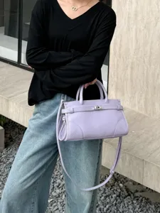 Lavender leather Kelly handbag with top handle and shoulder strap for women, vintage style.