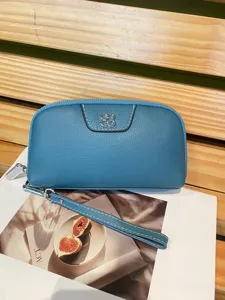 Blue leather clutch bag for women, stylish daily wristlet wallet with metal flower decor.