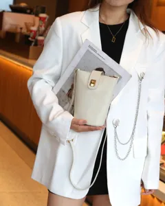 Cream leather crossbody bucket bag with gold lock detail, stylish womens mini phone bag.