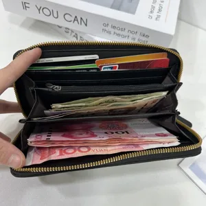 Portafoglio lungo in pelle nera da donna, chiusura lampo, scomparti per carte e contanti.