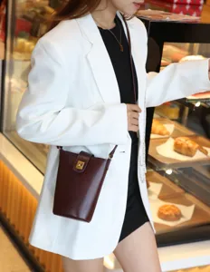 Minimalist genuine leather bucket bag for women, stylish crossbody phone purse and chic handbag.