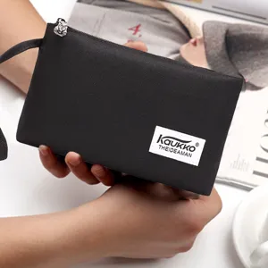 Black nylon clutch bag detail, mini wallet purse with zipper and wrist strap for use.