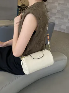 Chic leather cylinder shoulder bag with colorful beaded strap, stylish everyday crossbody purse.