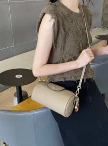 Genuine leather cylindrical shoulder bag, stylish crossbody handbag for women daily wear.