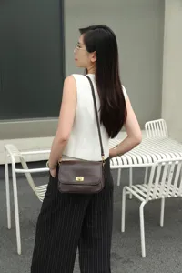 Detail shot of vintage leather shoulder bag, premium top-layer cowhide, classic retro design.