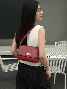 Red leather shoulder bag for women, vintage flap crossbody bag with metal turn-lock closure.