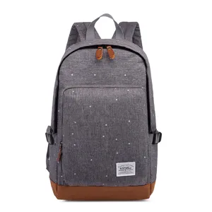 Grey canvas polka dot backpack with brown leather bottom ideal for daily school use.