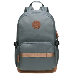 Casual grey school backpack with brown leather accents and front pocket storage for daily use.