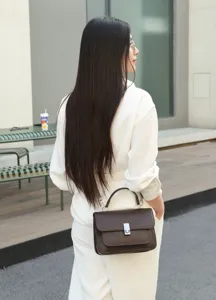 Detailed close-up view of women's genuine leather crossbody shoulder bag in dark brown.