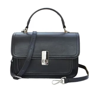 Classic black leather crossbody bag with top handle and metal clasp for chic everyday wear.