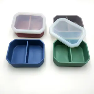 Portable silicone lunch box with 2 compartments and lid for daily meals and food storage.