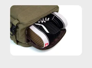 Green canvas backpack detail view showcasing bottom shoe storage compartment capacity.