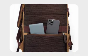 Canvas backpack back detail showing breathable mesh padding and zippered pocket storage capacity.