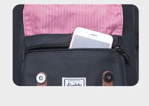 Detailed shot of black backpack front pocket with red white striped lining and phone.