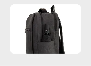 Casual dark gray canvas backpack detail with side umbrella pocket and durable material.