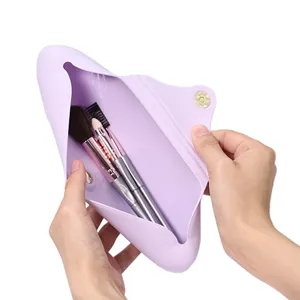 Portable silicone makeup brush holder travel cosmetic storage pouch in light purple color.
