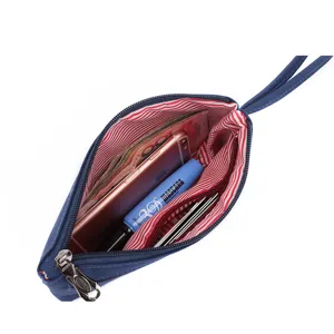 Blue nylon canvas wristlet pouch with red striped lining, compact daily storage organizer bag.