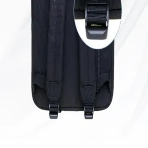 Black backpack strap detail showing durable fabric and sturdy adjustable plastic buckle closeup.